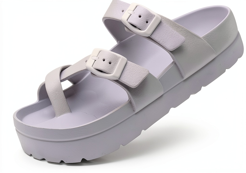 Womens slide sandals with double buckle straps on a beach